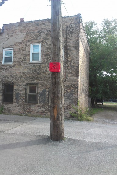 A homemade basketball hoop in a Humboldt Park alley.